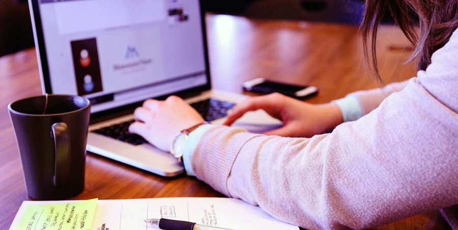 Close up of hands operating a laptop computer
