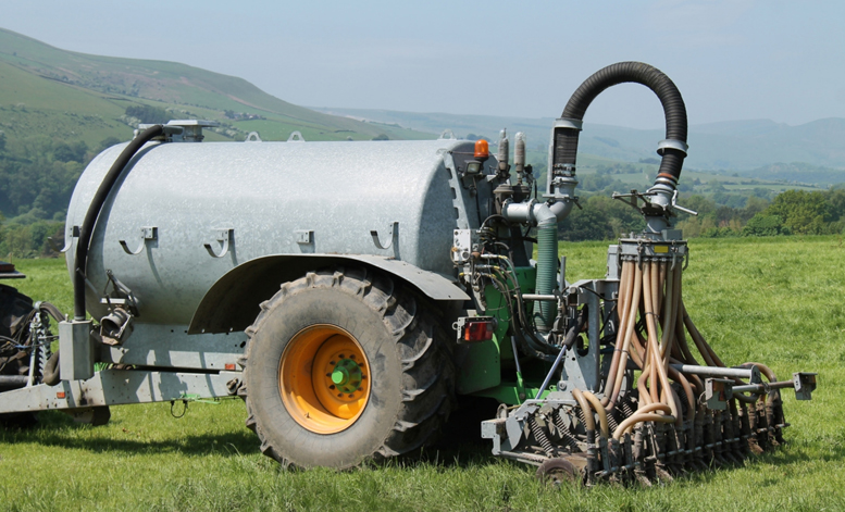 Slurry tanker in a field in summer